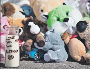  ?? CP PHOTO ?? A memorial sits outside of the home of Nathan Dumas, the seven-year-old boy who was allegedly murdered by his stepfather, Justin Kuijer, Wednesday in St. Catharines, Ont. Kuijer, who is facing charges of first-degree murder as well as attempted murder...