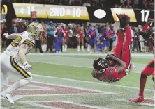  ?? AP PHOTO ?? TOP PICK: Deion Jones intercepts a pass intended for the Saints’ Josh Hill (left) to help seal the Falcons’ 2017 victory last night in Atlanta.