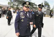  ?? Fernando Antonio / Associated Press ?? New Police Chief Jose David Aguilar Moran (center) reportedly helped deliver a ton of cocaine.
