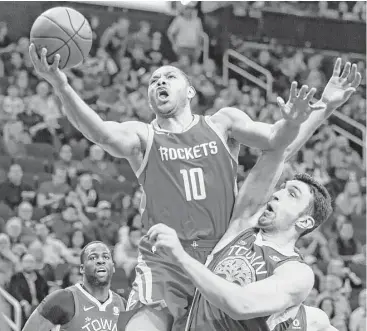  ?? Brett Coomer / Houston Chronicle ?? Eric Gordon drives to the basket against Golden State’s Zaza Pachulia during the first quarter at Toyota Center on Saturday. Gordon will defend his 3-point shooting title at the NBA’s All-Star Weekend next month.