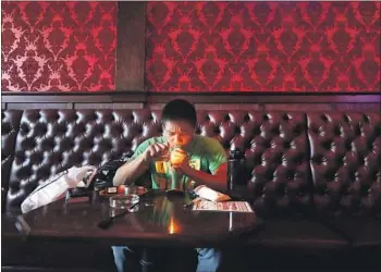  ?? Photograph­s by Jeff Chiu Associated Press ?? MICHAEL LEONOR uses marijuana in the smoking lounge at Barbary Coast Collective in San Francisco.