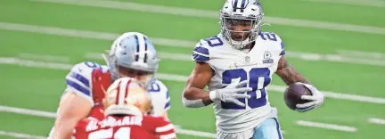  ?? TIM HEITMAN/USA TODAY SPORTS ?? Cowboys running back Tony Pollard carries against the San Francisco 49ers on Sunday in Arlington, Texas. Dallas won 41-33 to improve to 5-9 on the season, while the 49ers fell to 5-9.