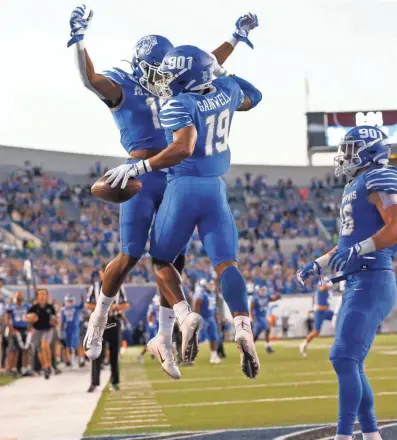  ?? JOE RONDONE/THE COMMERCIAL APPEAL ?? Memphis running back Kenneth Gainwell celebrates his touchdown with Kedarian Jones against Tulane during their game at the Liberty Bowl Memorial Stadium on Saturday.