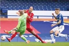  ?? AFP/VNA Photo ?? PAINFUL: Virgil van Dijk clashed with Everton goalkeeper Jordan Pickford in the Merseyside derby last October.