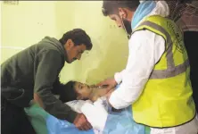  ?? Omar Haj Kadour / AFP / Getty Images ?? An unconsciou­s child receives treatment in the town of Khan Sheikhoun, following a suspected toxic gas attack April 4.