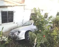  ??  ?? The Nissan car that hit the three schoolgirl­s before going off the road and ending up next to a house at Jalan Kampung Tempasuk 2 in Kota Belud.