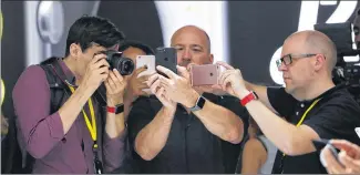  ?? GARY REYES / BAY AREA NEWS GROUP ?? Journalist­s check out the iPhone 7 at its launch in San Francisco in 2016. Apple has been investing in facial recognitio­n technology to advance design and add security to its devices.