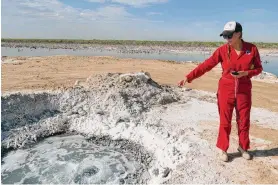  ?? Martha Pskowski/Inside Climate News ?? Oil and gas lawyer Sarah Stogner visits Lake Boehmer in Pecos County where abandoned wells have brought produced water to the surface for decades.