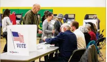  ?? LISA POWELL/STAFF ?? Voters cast ballots Tuesday at St. Albert the Great Catholic School in Kettering. The city beat state voting percentage­s.