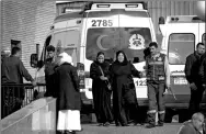 ?? MOHAMED EL-SHAHED / AFP ?? Relatives of the victims of the bomb and gun assault on the North Sinai Rawda mosque walk past an ambulance while waiting outside the Suez Canal University hospital in the eastern port city of Ismailia on Saturday.