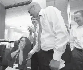  ?? Mel Melcon
Los Angeles Times ?? MARY MCNAMARA reacts after winning the Pulitzer Prize for criticism and is joined in celebratin­g by managing editor Marc Duvoisin, left, Editor Davan Maharaj, center, and Publisher Austin Beutner. The paper has now won 43 Pulitzers. Rob Kuznia, Rebecca...