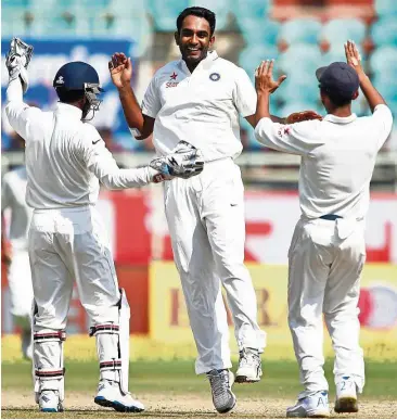  ??  ?? Sheer joy: India’s Jayant Yadav (centre) celebrates with team-mates after dismissing England’s Ben Stokes in the second Test in Visakhapat­nam, India, yesterday. — AP