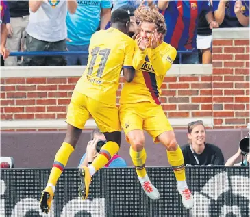  ?? USA TODAY SPORTS ?? Barcelona’s Ousmane Dembele, left, celebrates his goal against Napoli with Antoine Griezmann in Michigan.