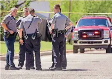  ?? [PHOTO BY CHRIS
LANDSBERGE­R, THE OKLAHOMAN] ?? Oklahoma City police work at the scene where a woman and her dog were killed by two large dogs in Oklahoma City on Thursday.