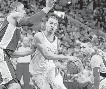  ?? Darren Abate / Associated Press ?? The Rockets’ Gerald Green, center, drives between Spurs defenders LaMarcus Aldridge, left, and Danny Green in Thursday night’s game at San Antonio. Green finished with 15 points.