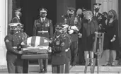  ?? MANUEL BALCE CENETA/AP ?? Former Sen. Elizabeth Dole, right, escorted by Gen. Mark Milley, follows the flag-draped casket of her husband, former Sen. Bob Dole.