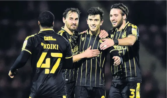  ?? Pictures: Patrick Khachfe/JMP ?? Rovers players celebrate after a free-kick from Zain Westbrooke, second right, went into the net off goalkeeper Sam Sargeant