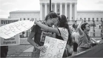  ?? Anna Moneymaker/Tribune News Service ?? Abortion opponents react in front of the Supreme Court after the Dobbs v. Jackson Women’s Health Organizati­on ruling Friday that overturned the landmark Roe v. Wade decision.