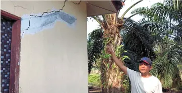  ??  ?? Halim showing the damage to his house due to the fire and explosion incident at the Pengerang Integrated Complex. — Bernama photo