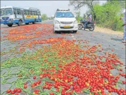  ?? PTI ?? Vegetables dumped by farmers lie scattered on a road on the third day of the farmer’s protest in Haryana’s Hisar on Sunday.