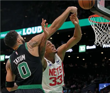  ?? STUART CAHILL — BOSTON HERALD ?? Boston Celtics forward Jayson Tatum and Brooklyn Nets center Nic Claxton battle for the rebound as the Celtics take on the Nets at the TD Garden.