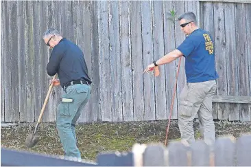  ?? [RICH PEDRONCELL­I/THE ASSOCIATED PRESS] ?? Authoritie­s probe the backyard of the home of murder suspect Joseph DeAngelo, Thursday in Citrus Heights, Calif. DeAngelo, 72, was taken into custody Tuesday on suspicion of committing multiple homicides and rapes in the 1970s and 1980s in California....