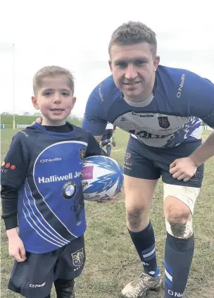  ??  ?? Under 7s player Toby Boyd, pictured with Blues captain Ryan Parkinson, was the mascot on Saturday