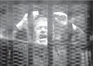  ?? Ali Malki Al Masr y al Youm ?? FORMER President Mohamed Morsi, seen during the reading of the verdict, had been found guilty of spying and plotting a prison break amid protests in Egypt against President Hosni Mubarak in January 2011.