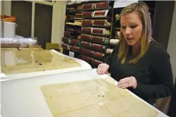  ?? Staff photo by Jim Williamson ?? ■ Little River County Circuit Clerk Lauren Abney looks at some of the bound copies of documents in the Ashdown, Ark., courthouse. The Clerk’s Office received a $20,000 grant to digitize and index the county land and real estate books. Some of the books...