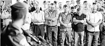  ??  ?? Israeli security forces stand guard in front of Palestinia­n Muslim worshipper­s praying outside Lions Gate, a main entrance to the Al-Aqsa mosque compound in Jerusalem’s Old City as the latter protest against new Israeli security measures implemente­d at...