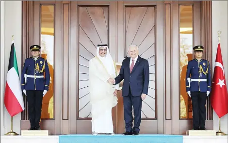  ?? (AFP) ?? Turkish Prime Minister Binali Yildirim (center right), shakes hands with Prime Minister of Kuwait, Sheikh Jaber Al-Mubarak Al-Hamad Al-Sabah, ahead of their meeting at Cankaya Palace in Ankara, on Sept 14.
