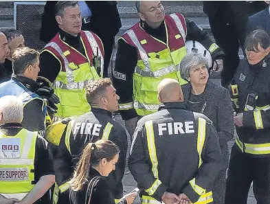  ?? Pictures: PA/Getty/AP. ?? The charred and smoulderin­g Grenfell Tower block, top; London Mayor Sadiq Khan who was heckled during his visit to the site, top right; Prime Minister Theresa May speaks to members of the fire service at the scene, above; and, far right, the blaze at...