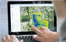  ?? ALAIN JOCARD/ GETTY IMAGES FILES ?? French Airinov’s commercial director Romain Faroux studies on a computer screen a picture taken by a drone made by the start- up company specialise­d in drone aerial photograph­y on Feb. 19, 2013 in France. The picture shows the agronomic diagnosis which...