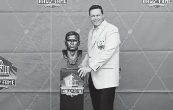  ?? DAVID DERMER AP ?? Former NFL player Tony Boselli poses with his bust during an induction ceremony at the Pro Football Hall of Fame. ‘I thank God for football and I thank God for the people of Jacksonvil­le,’ Boselli said during his induction.