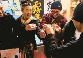  ?? NICO SCHINCO/THE NEW YORK TIMES ?? Customers toast Feb. 18 at Kuraichi, a sake shop in the Brooklyn borough of New York City.