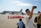  ?? Photograph: Xinhua/Shuttersto­ck ?? Passengers take photos with a C919, China’s self-developed large passenger aircraft