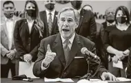  ?? Jay Janner / Associated Press ?? Texas Gov. Greg Abbott speaks before signing a “Texas Backs the Blue Pledge.” It’s a gimmicky approach that serves Abbott’s immediate political purposes.