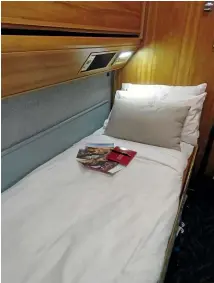  ?? JUSTINE TYERMAN ?? My comfy bed and compliment­ary postcards on The Ghan.