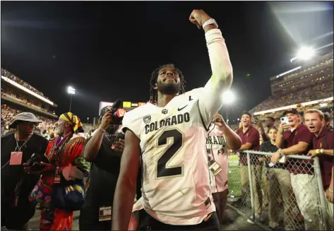  ?? CHRISTIAN PETERSEN — GETTY IMAGES ?? Colorado quarterbac­k Shedeur Sanders celebrates as he walks off the field following the Buffs’ 27-24 win against the Arizona State on Saturday in Tempe, Ariz.