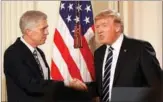  ?? KEVIN LAMARQUE / REUTERS ?? US President Donald Trump shakes hands with Neil Gorsuch after nominating him to be an associate justice of the US Supreme Court at the White House in Washington on Tuesday.