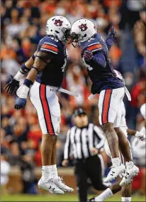  ?? BRYNN ANDERSON / AP ?? Linebacker Robert Muschamp (left), defensive back Stephen Roberts and their Auburn teammates will have to defeat Georgia a second time to qualify for the College Football Playoff. The first meeting was less than three weeks ago.