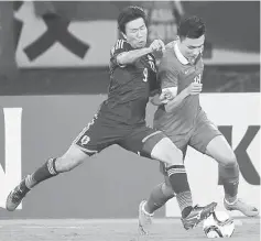  ??  ?? Kensuke Nagai of Japan fights for the ball with Gao Lin (right) of China during their men’s East Asian Cup football match at the Wuhan Sports Centre Stadium in Wuhan in this August 9 file photo. — AFP photo