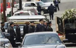  ?? — AFP ?? Step by step: Pallbearer­s carrying the casket of Houston to a hearse outside the New Hope Baptist Church after funeral services in Newark, New Jersey.