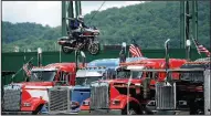  ?? AP/Tribune-Democrat/JOHN RUCOSKY ?? Cole Freeman of St. Charles, Mo., successful­ly jumps over five tractor-trailer trucks on a fully-dressed Harley-Davidson motorcycle, setting a world record, during the 21st annual Thunder in the Valley motorcycle rally in Johnstown, Pa., on Saturday.