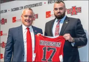  ?? (Arkansas State Athletics/Carla Wehmeyer) ?? New Arkansas State men’s basketball Coach Bryan Hodgson (right) was introduced by Athletic Director Jeff Purinton on Monday at the school in Jonesboro. “This was something that I was called to do,” said Hodgson, noting his patience as an assistant coach for the right opportunit­y to come to oversee a program.