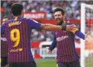  ?? Miguel Morenatti / Associated Press ?? Barcelona’s Lionel Messi (right) celebrates with Luis Suarez after completing a hat trick.