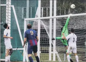  ??  ?? CLOSE CALL Andrew Todd sends a looping header towards goal, but Binfield keeper Chris Grace gets back to finger-tip it over the bar
Pictures: Tom Phillips