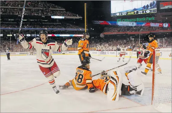  ?? — REUTERS FILES ?? New York Rangers’ Brad Richards, left, celebrates after scoring the winning goal on Philadelph­ia Flyers’ Sergei Bobrovsky in January’s Winter Classic in Philadelph­ia. This season’s event has been cancelled because of the NHL lockout.