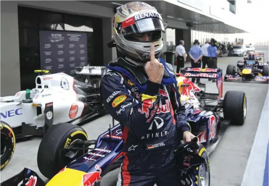  ??  ?? Red Bull driver Sebastian Vettel of Germany gestures after winning pole position for today’s Indian F1 Grand Prix
Photograph: AP