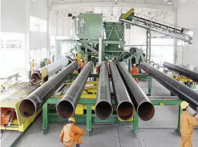  ??  ?? Pipes being coated at Wah Seong Corp Bhd’s pipecoatin­g plant.